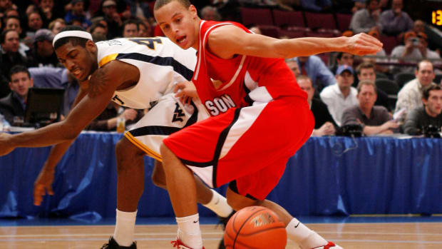 Davidson Wildcats guard Stephen Curry reaches for a loose ball.
